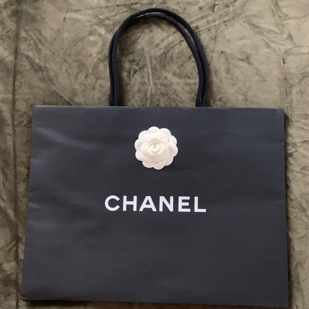 Authentic CHANEL Black Paper Bag with White Camelia